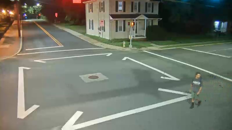 Unknown suspect walking across the street.