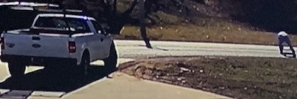 Man standing outside white Ford truck