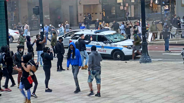 Suspect 1 is a male with long hair in a blue hoodie and jeans.