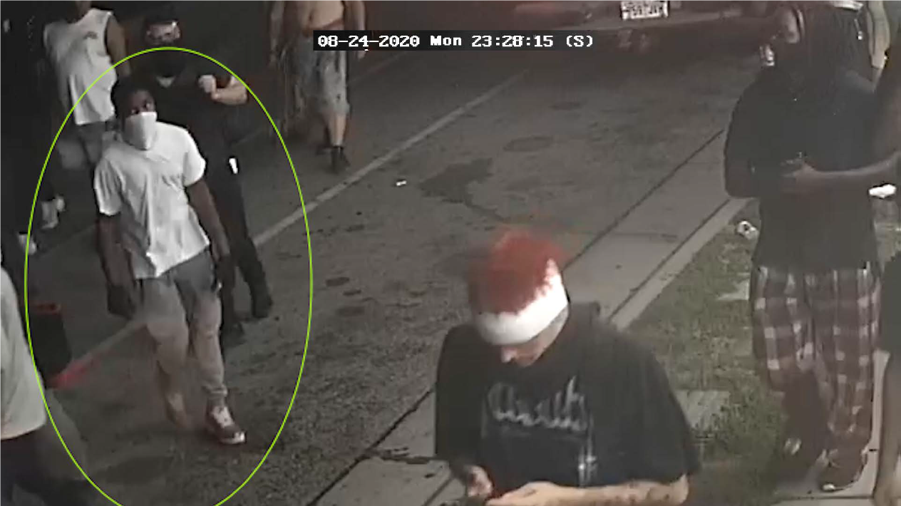 Male in white shirt and tan pants with a white face covering, identified as UNSUB #32.