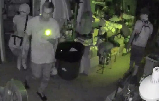 Surveillance image of three individuals with masks on inside Panther City Firearms.