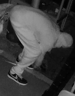 A person bending over away from the camera