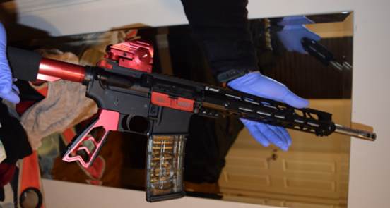 AR-15-style rifle with the words “SUU WHOOP” inscribed on it.