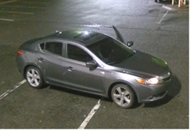 A silver car in a parking lot.