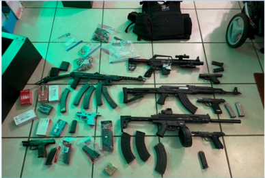 Multiple firearms and other items.