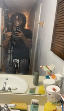 Court exhibit photograph of a person taking a photo in front of a mirror.