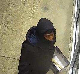 A person in a dark-colored hood and jacket.