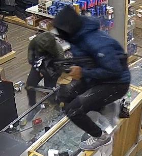 Two people moving inside of a store.