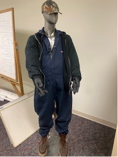 A mannequin wearing a hat and clothing.