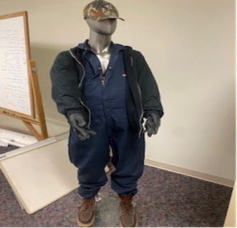 Photo of law enforcement seized articles of clothing, multiple masks, the firearm, handwritten notes, and brown boots associated with the robberies.