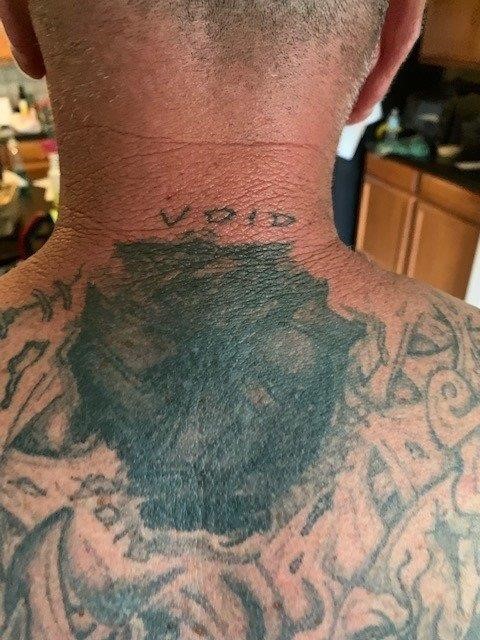 Man #2 with mutilated gang tattoo.
