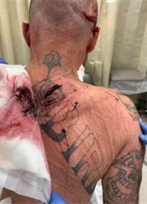 Man #4 with mutilated gang tattoo.