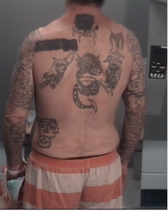 Man #3 with mutilated gang tattoo.