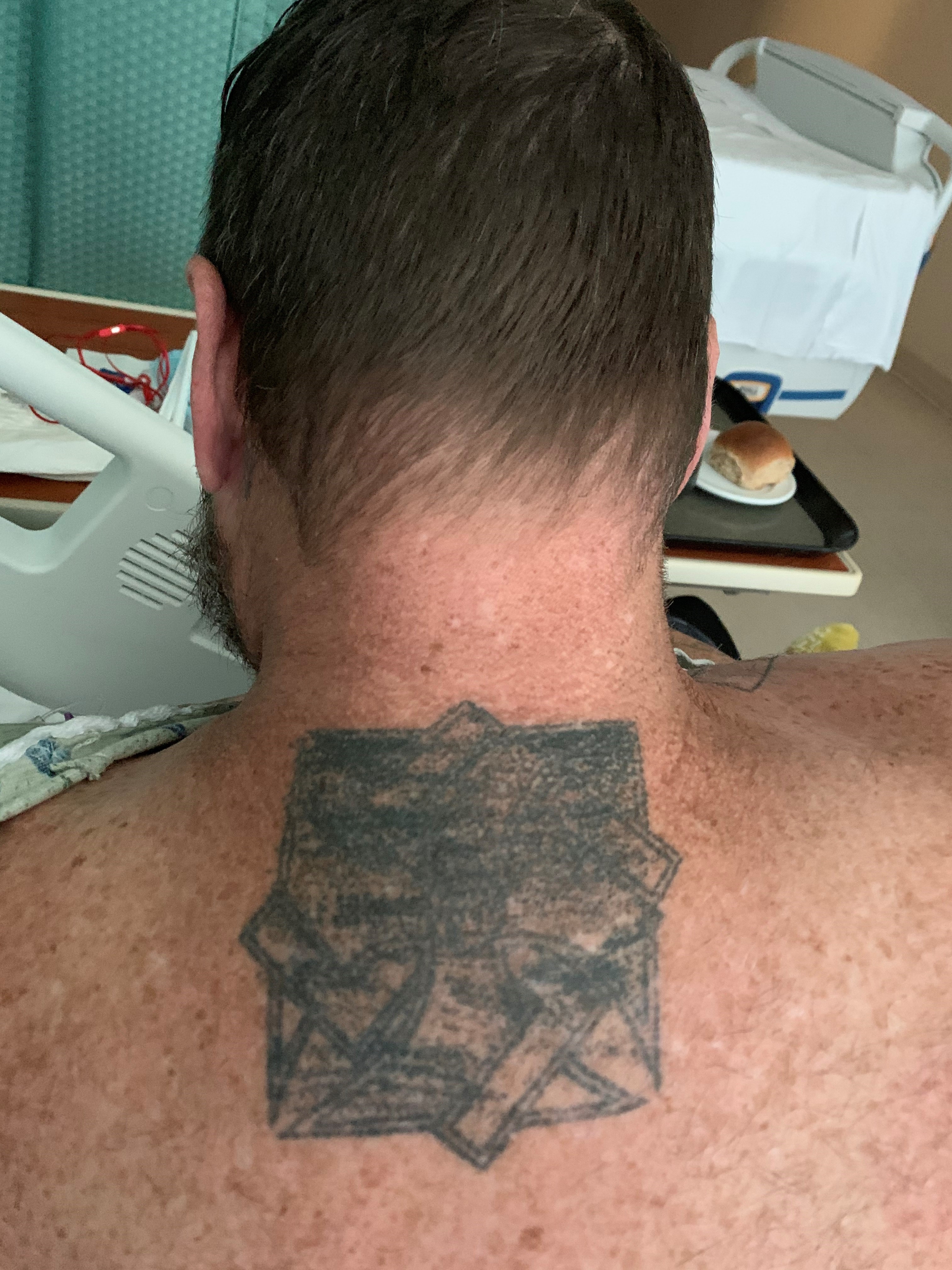 Man one with destroyed gang tattoo.
