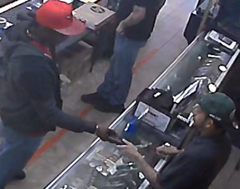 Wilson holding and inspecting a firearm at an FFL in January 2023