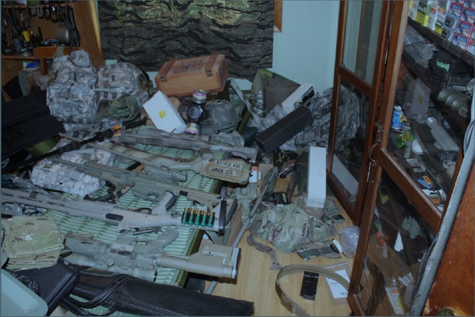Guns, bullets and bulletproof vest lying on a table