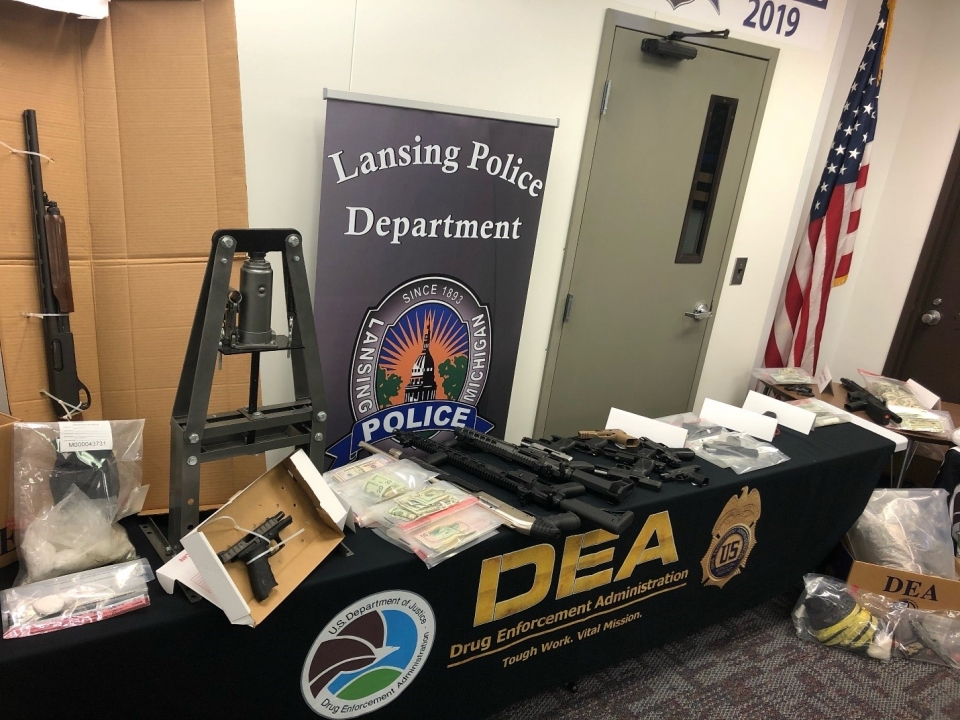 Guns and money seized lying on a DEA table