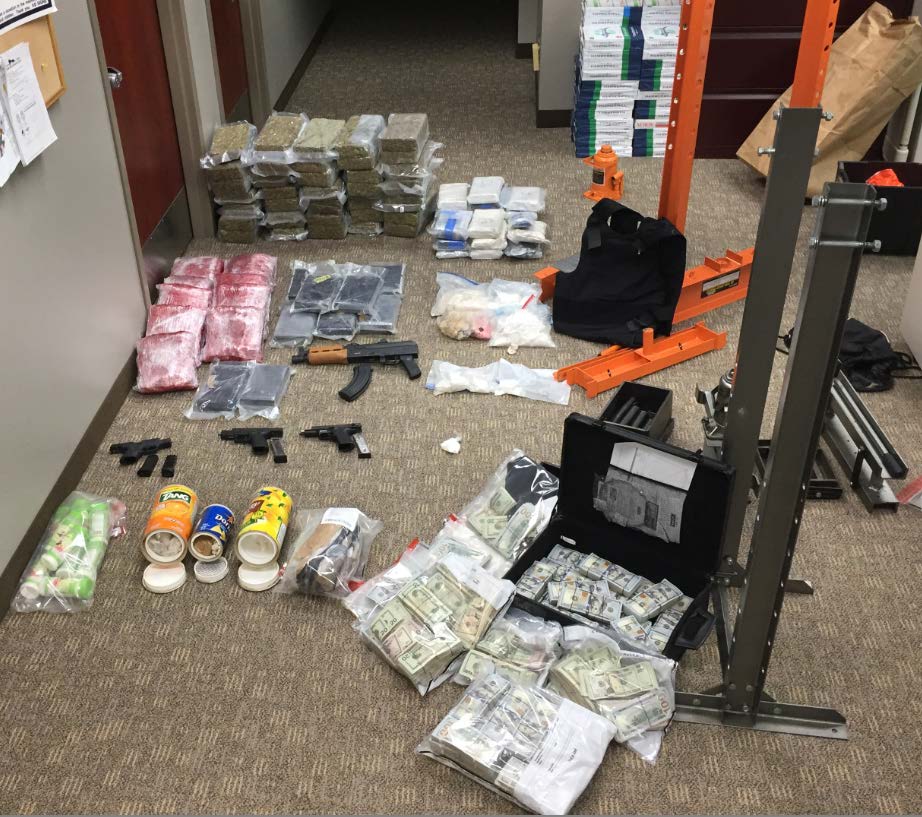 Guns, drugs and money seized lying on the ground