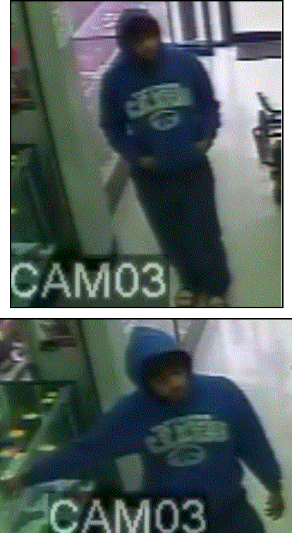 Suspect walking in store with a blue hoodie on