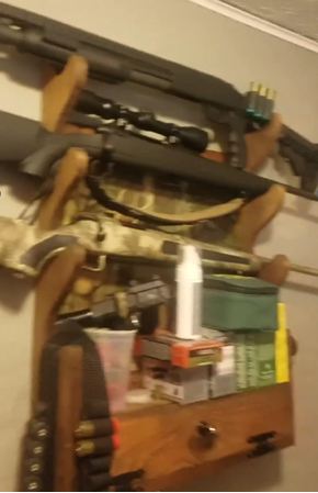 Shotguns hanging on wall with extra bullets