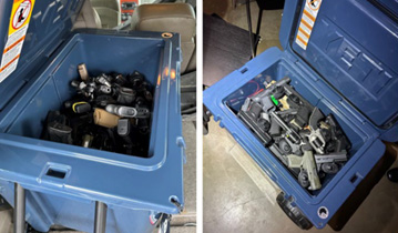 Two blue Yeti coolers full of firearms.