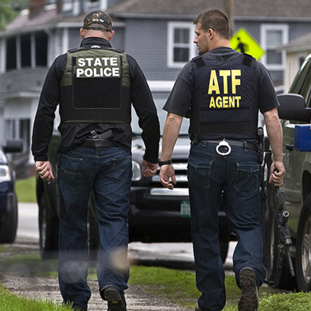 ATF Special Agent and State Police Officer mid discussion while walking down sidewalk