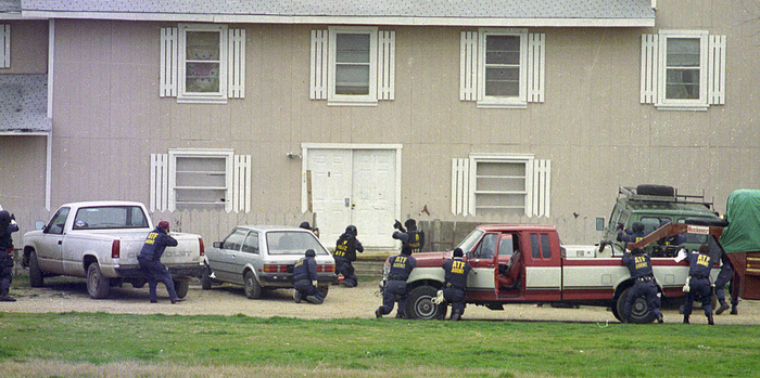 ATF agents line up behind cars and trailers during the opening moments of the raid